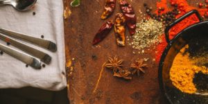 Colorful spices arranged near a cooking pan